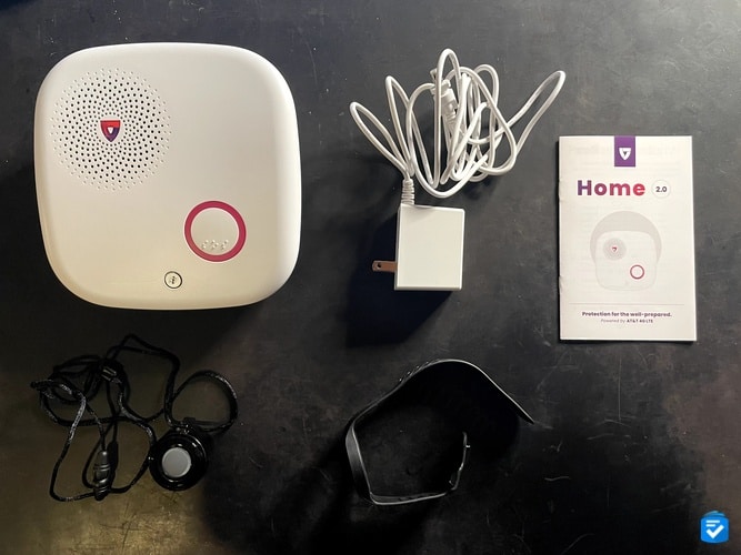 My Medical Guardian MGHome Cellular included a base unit, an AC power adapter, a manual, a help button (displayed in the pendant attachment), and a bracelet attachment.